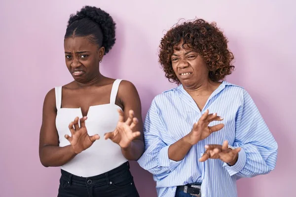 Two African Women Standing Pink Background Disgusted Expression Displeased Fearful — Stok fotoğraf