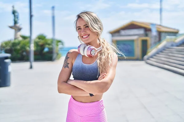 Junge Blonde Frau Sportkleidung Steht Mit Verschränkten Armen Meer — Stockfoto
