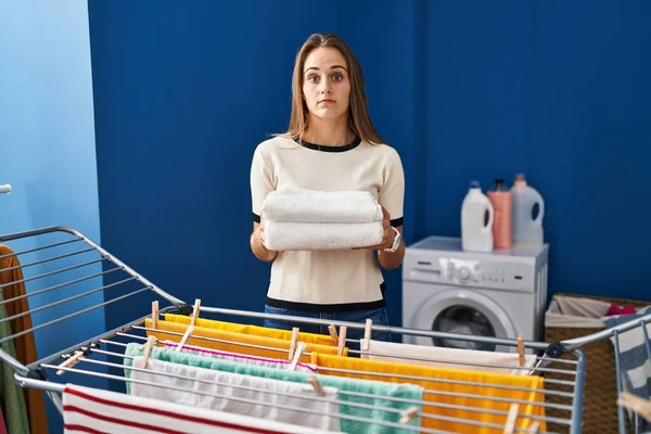 Young Woman Holding Clean Laundry Clothesline Clueless Confused Expression Doubt — Fotografia de Stock