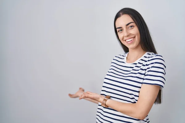 Young Brunette Woman Wearing Striped Shirt Inviting Enter Smiling Natural — ストック写真