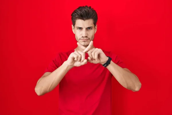 Young Hispanic Man Standing Red Background Rejection Expression Crossing Fingers — Stock Photo, Image