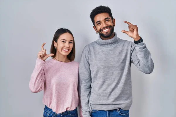 Young Hispanic Couple Standing Together Smiling Confident Gesturing Hand Doing — Stockfoto
