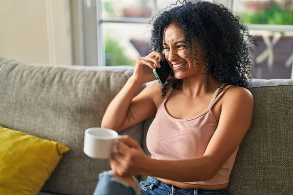 Young Hispanic Woman Drinking Coffee Talking Smartphone Home — Stock fotografie