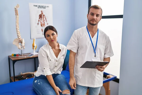Young Hispanic Woman Physiotherapist Appointment Relaxed Serious Expression Face Simple — Stockfoto