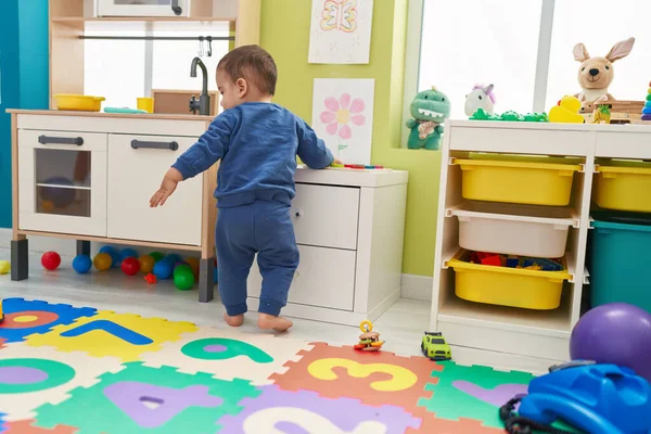 Adorable Hispanic Toddler Playing Play Kitchen Standing Kindergarten — Stok fotoğraf