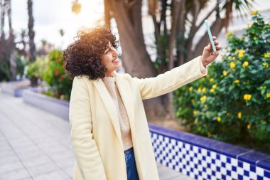 Young middle east woman excutive smiling confident make selfie by smartphone at park