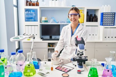 Laboratuvarda makyaj yapan genç İspanyol bilim kadını.