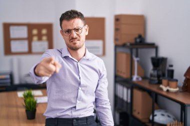 Ofisteki genç İspanyol adam kameraya kızgın ve sinirli bir şekilde seni işaret ediyor. 