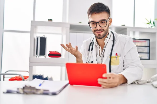Young Hispanic Man Doctor Using Touchpad Having Video Call Clinic — Stock Photo, Image