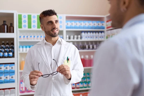 Two Hispanic Men Pharmacist Speaking Client Holding Glasses Pharmacy — Stockfoto