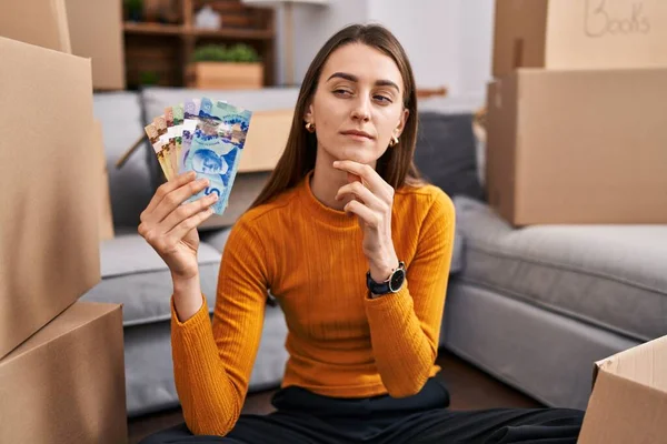 Young Caucasian Woman Sitting Floor New Home Holding Canadian Money — Stock Photo, Image