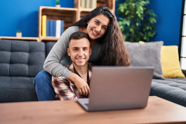 Man and woman couple watching movie at home