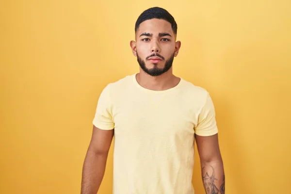Young Hispanic Man Standing Yellow Background Relaxed Serious Expression Face — Stock Photo, Image