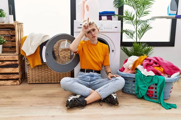 Young Blonde Woman Doing Laundry Sitting Washing Machine Making Fun — Stockfoto