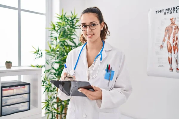 Young Beautiful Hispanic Woman Doctor Smiling Confident Writing Medical Report — Stock Photo, Image