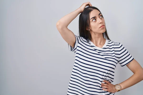 Young Brunette Woman Wearing Striped Shirt Confuse Wondering Question Uncertain — стоковое фото