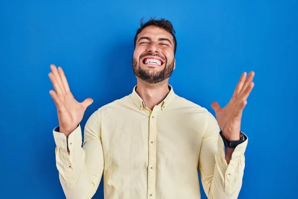 Handsome Hispanic Man Standing Blue Background Celebrating Mad Crazy Success — Stockfoto