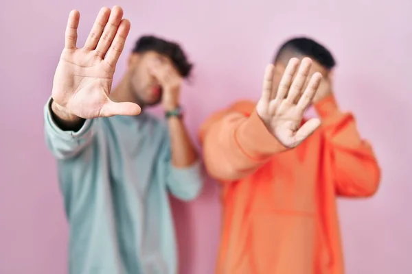 Young Hispanic Gay Couple Standing Pink Background Covering Eyes Hands — Fotografia de Stock
