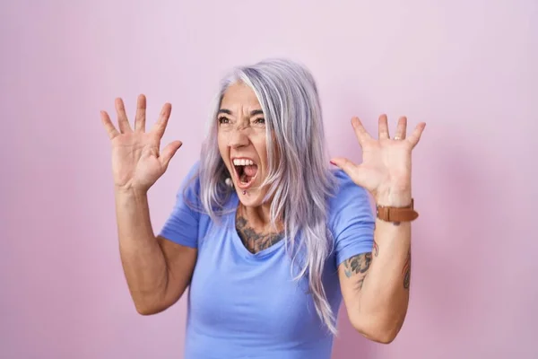 Žena Středního Věku Tetováním Stojící Nad Růžovým Pozadím Oslavující Šílenost — Stock fotografie
