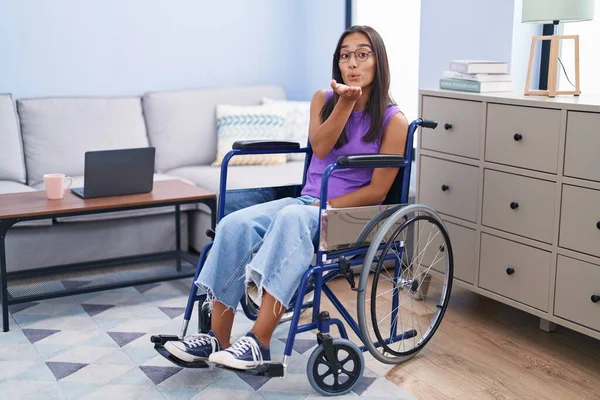 Young Hispanic Woman Sitting Wheelchair Home Looking Camera Blowing Kiss — Stock fotografie