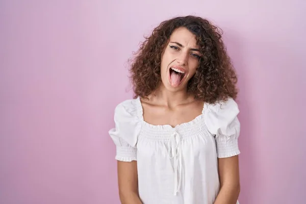 Hispanic Woman Curly Hair Standing Pink Background Sticking Tongue Out —  Fotos de Stock
