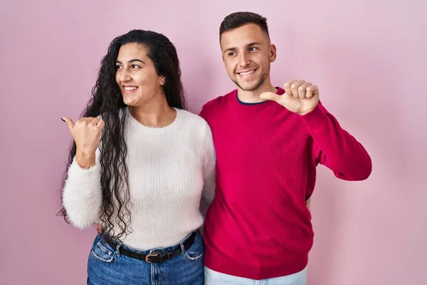 Young Hispanic Couple Standing Pink Background Smiling Happy Face Looking — Fotografia de Stock