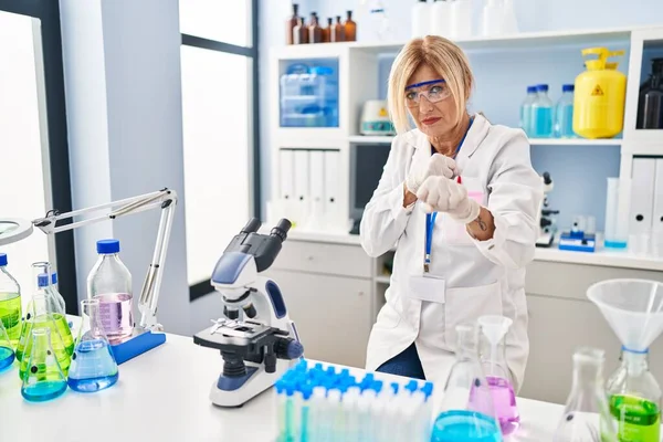 Middle Age Blonde Woman Working Scientist Laboratory Punching Fist Fight — Stock Photo, Image