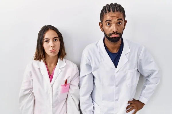 Young Hispanic Doctors Standing White Background Depressed Worry Distress Crying —  Fotos de Stock