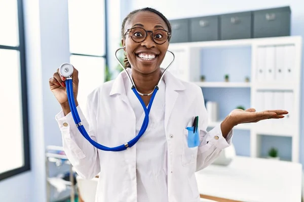 Black Doctor Woman Holding Stethoscope Celebrating Achievement Happy Smile Winner — Zdjęcie stockowe