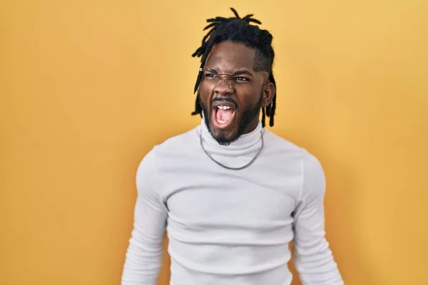 African Man Dreadlocks Wearing Turtleneck Sweater Yellow Background Angry Mad — Stock Photo, Image