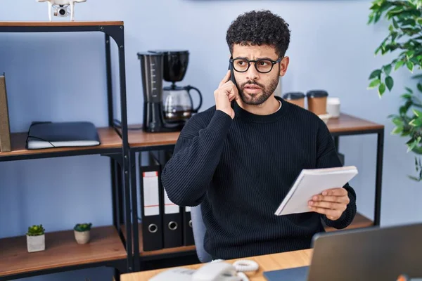 Young Arab Man Business Worker Talking Smartphone Reading Notebook Office — Stockfoto