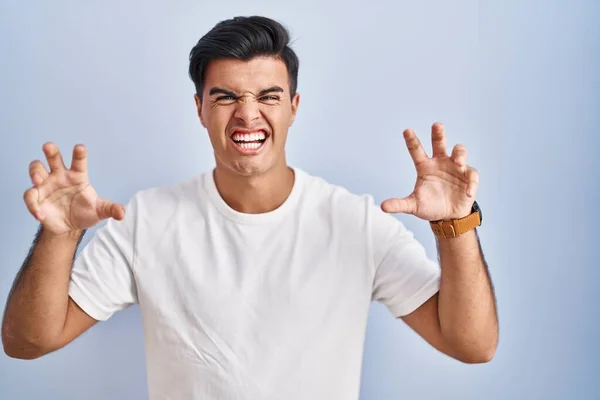 Hispanic Man Standing Blue Background Smiling Funny Doing Claw Gesture — Stock Photo, Image