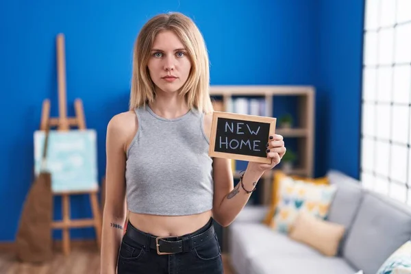 Blonde Caucasian Woman Holding Blackboard New Home Text Thinking Attitude — Stockfoto