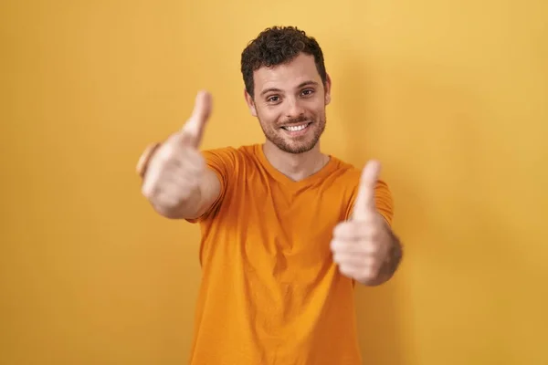Young Hispanic Man Standing Yellow Background Approving Doing Positive Gesture — Stockfoto