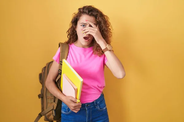 Young Caucasian Woman Wearing Student Backpack Holding Books Peeking Shock — Photo