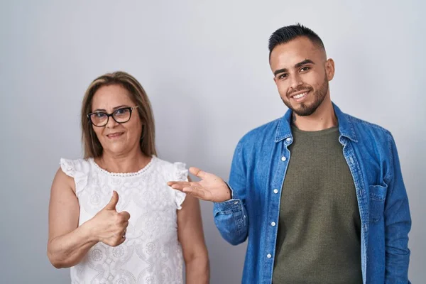 Hispanic Mother Son Standing Together Showing Palm Hand Doing Gesture — Foto de Stock