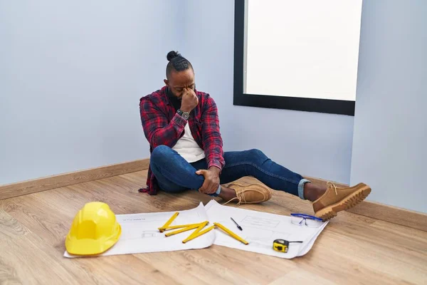 African American Man Sitting Floor New Home Looking Blueprints Tired — Fotografia de Stock