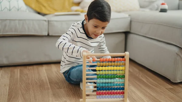 Adorable Hispanic Boy Playing Abacus Sitting Floor Home — Zdjęcie stockowe