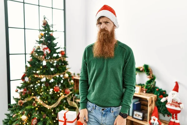 Redhead Man Long Beard Wearing Christmas Hat Christmas Tree Skeptic — Zdjęcie stockowe