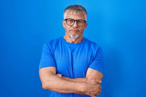 Hispanic Man Grey Hair Standing Blue Background Skeptic Nervous Disapproving — Stockfoto