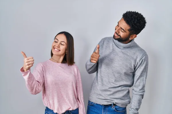 Young Hispanic Couple Standing Together Looking Proud Smiling Doing Thumbs — 图库照片