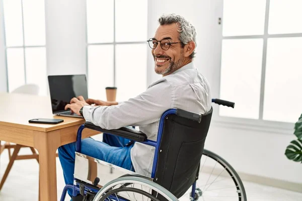 オフィスで働く車椅子に座っている中年の白髪のサラリーマン — ストック写真