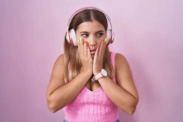 Young Blonde Woman Listening Music Using Headphones Tired Hands Covering — Foto de Stock