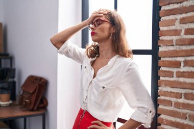 Young beautiful hispanic woman business worker stressed standing at office