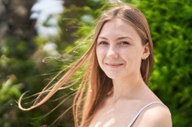 Young caucasian woman smiling confident standing at park