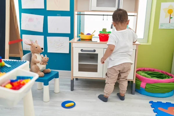 Adorable Hispanic Toddler Playing Play Kitchen Standing Kindergarten —  Fotos de Stock