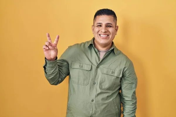 Hispanic Young Man Standing Yellow Background Smiling Looking Camera Showing — стоковое фото