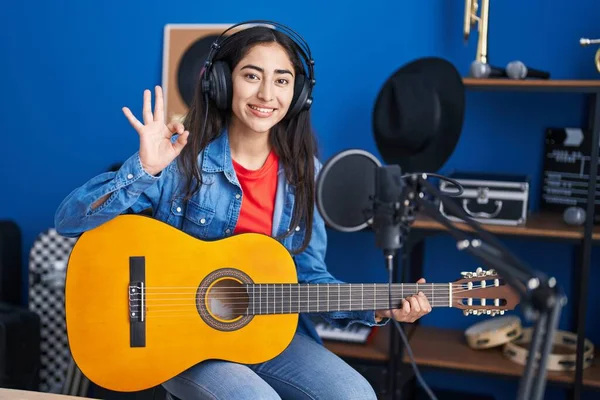 Young Teenager Girl Playing Classic Guitar Music Studio Doing Sign — Fotografia de Stock