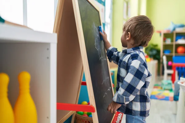 stock image Adorable hispanic boy preschool student drawing on blackboard at kindergarten