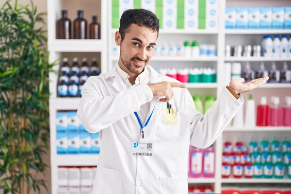 Handsome Hispanic Man Working Pharmacy Drugstore Amazed Smiling Camera While — Zdjęcie stockowe